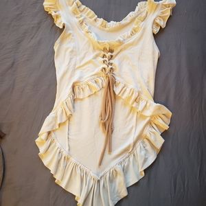 Cream cropped top with lacing on bust and ruffle detail